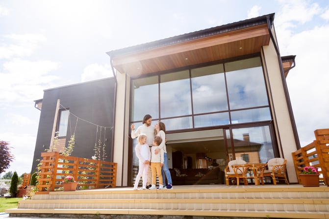 Family at the front porch of their vacation home